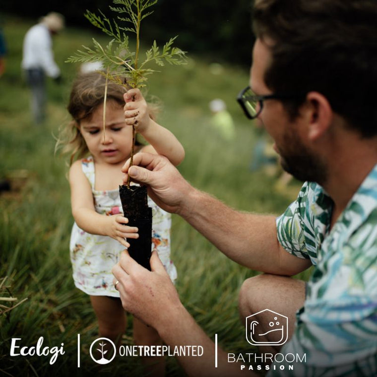 Father and daughter planting a tree