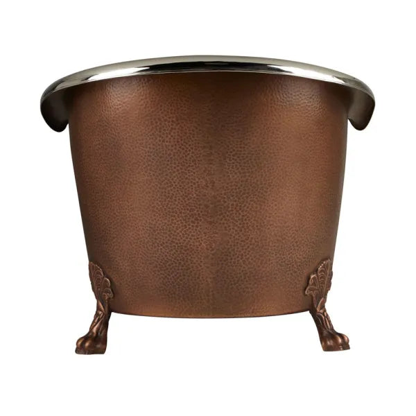 Coppersmith Creations Copper Clawfoot Tub featuring a nickel interior and antique hammered copper exterior. The elegant design includes decorative clawfoot legs, making it a stylish addition to any bathroom. Side view.