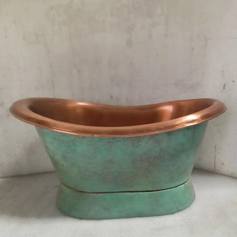 Coppersmith Creations Slanting Base Antique Copper Green Patina Basin next to concrete wall