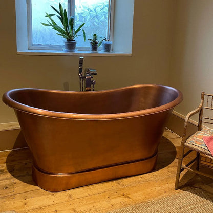 Coppersmith Creations Smooth Double Slipper Copper Bathtub 1680mm / 1830mm in bathroom setting next to window