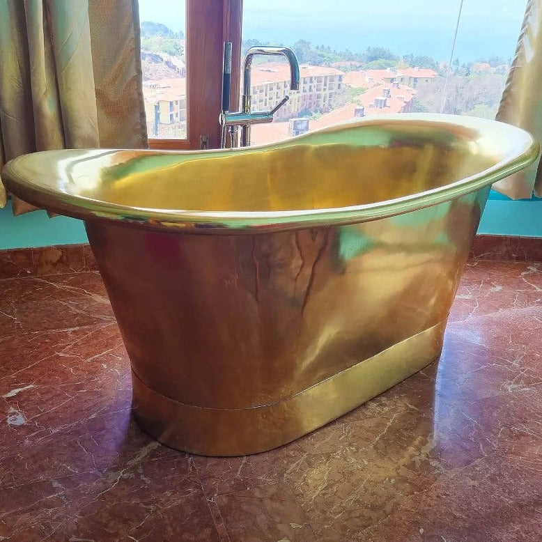 Coppersmith Creations Straight Base Brass Bathtub Full Polished Brass Finish 1700mm next to big window with freestanding tap